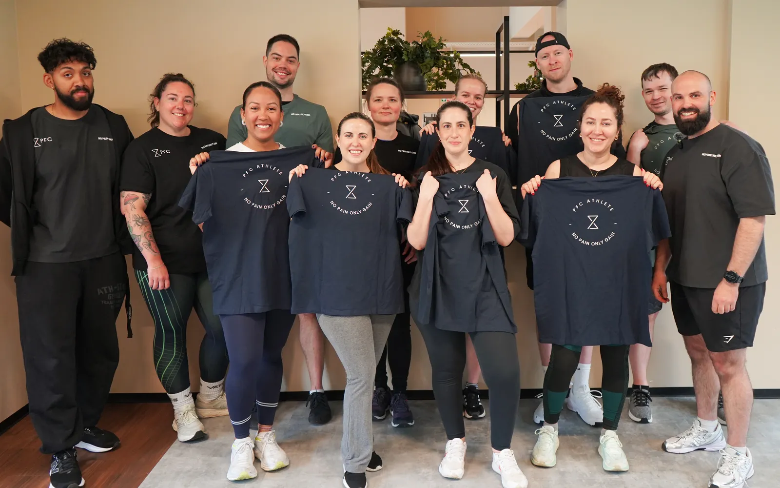 PFC clients holding branded shirts